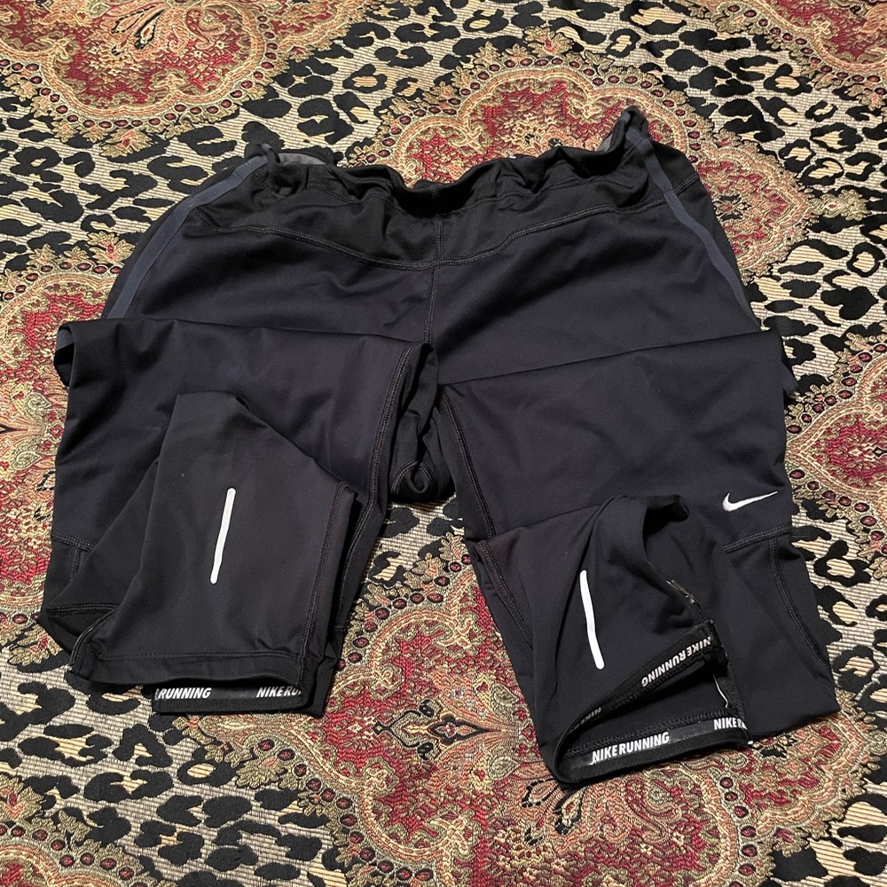 Women Nike reflective lined warm running pants w/zipper ankle. Large.